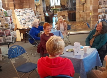 Customers enjoying fairtrade tea and coffee served by volunteers at Traidpoint Halesowen.