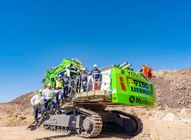 mining excavator with people posing on it