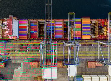 a container ship docked at a dock with containers and containers