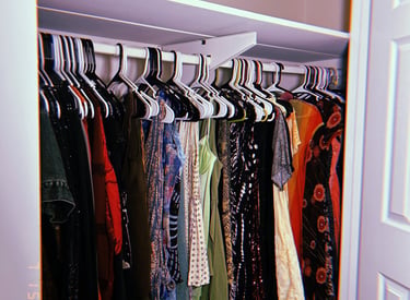 please center the clothing here to show the patterns and reduce how much of the hangers is showing