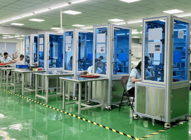a factory floor with a lot of people working on machines