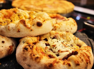 a bunch of pizzas on a table