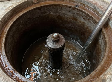 Nighttime shot of a Rapid Response truck parked by a home with crew repairing a broken septic line.