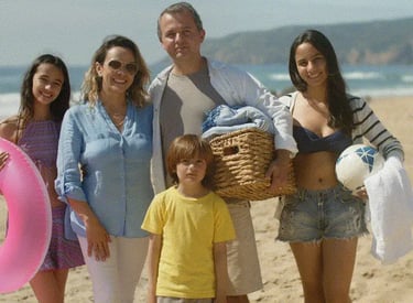 large latin family at the beach smiling