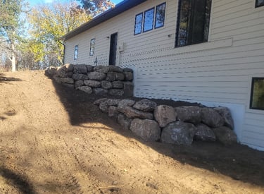 boulder wall behind home