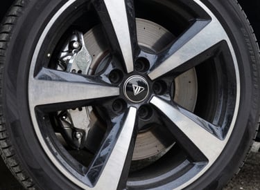 Technician performing brake fluid flush with specialized equipment inside a mobile unit.