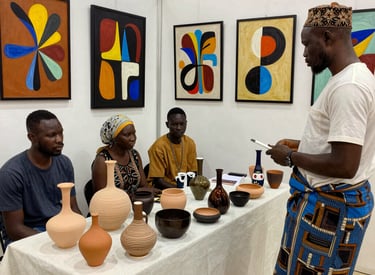 A vibrant gallery space filled with contemporary African artworks and visitors engaging deeply.