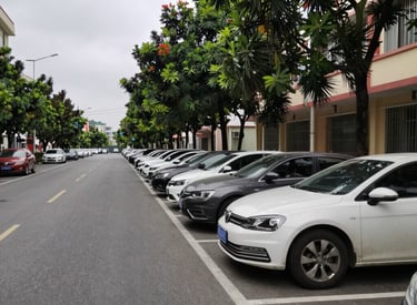 A disciplined security guard standing alert at a corporate building entrance during dusk.