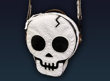 Skull purse made of full-grain cowhide embossed with an ostrich skin texture,.