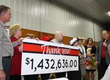 a man and woman standing in front of a sign that says thank you