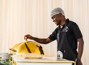 Catering staff serving food at an event buffet station