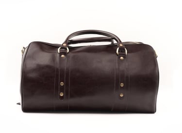 Geantă de voiaj din piele maro închis, fotografiată din față, centrată pe fundal alb.