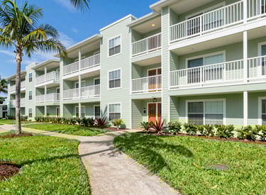 Shared building exterior showing well-maintained common areas and clean walkways.