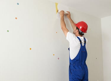 Close-up of a skilled carpenter fitting wooden floor panels in a modern home.