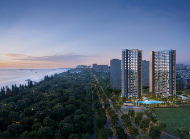 Luxury high-rise residential apartments at twilight overlooking a lush coastal park and ocean sunset.