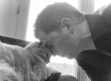 a man is holding a cat and a cat