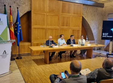 a group of people sitting at a table with a man in a suit and tie