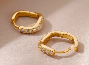 a pair of gold hoop earrings with diamonds