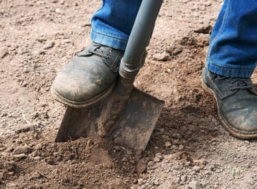 Simple shovel and shoes in the dirt