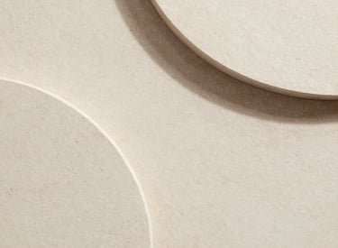 Lit candle and small dish on textured surface