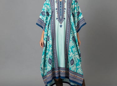 Close-up of hands selecting fabric samples with unique printed patterns on a wooden table.