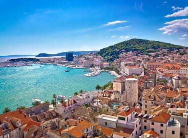 Panoramic view of Split, Croatia with red rooftops, the Adriatic Sea and Marjan Hill in the backgrou
