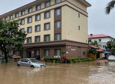 Technician using drying equipment in a flooded residential basement.