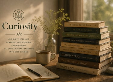 Stack of books beside a notebook and tea, representing curiosity, learning, and lifelong discovery.