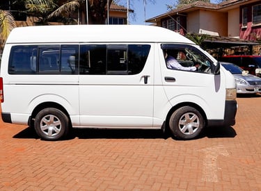 White passenger van shuttle for car hire and transportation services - Vanna Ventures