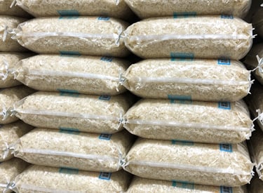 Close-up of authentic Thai jasmine rice bags neatly arranged on retail shelves.