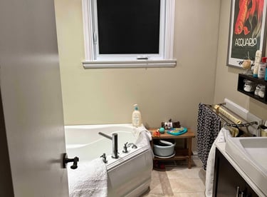 a bathroom with a tub in the corner
