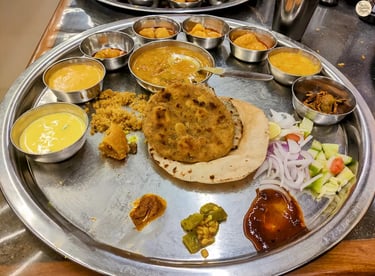 Rajasthani thali at Gypsy Restaurant Jodhpur with dal baati churma and traditional curries.