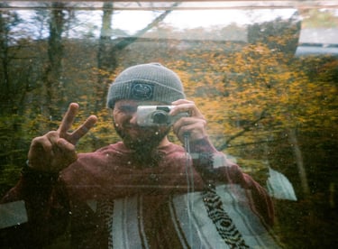 Car window selfie of Nate Bowery on film during fall in the Great Smoky Mountains.