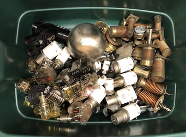 Metal parts in a sculptor's workshop bin, image 3.