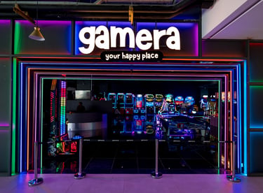a storefront door with a neon - lit sign that says gamera