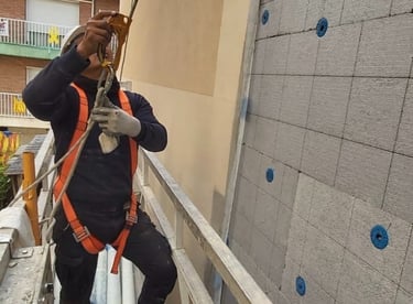 a man in a safety vest is taking a picture of a man in a safety