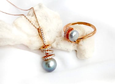 a necklace with a pearl and a ring