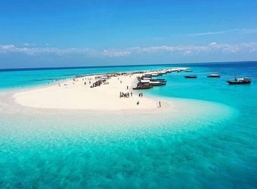 A stunning aerial view of Nakupenda Sandbank in Zanzibar, Tanzania, showcasing pristine white sand, turquoise waters