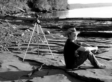 Photographer sitting on Lake Superior shore