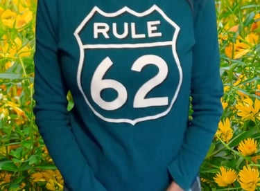 a woman in a green shirt Rule 62 on it