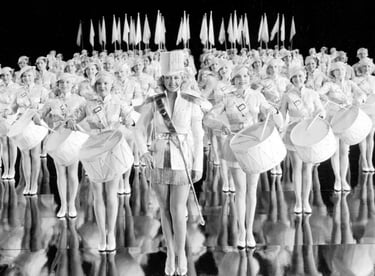 White-uniformed women in military formation – Gold Diggers of 1937 drill precision
