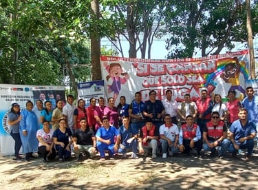 Regional health workers pose before a banner for International Day Against Child Labour in Ucayali.