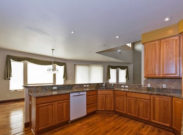 a kitchen with a stove top and a dishwasher