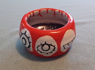 Celia - a bowl with various stages of an opening eye, with an iris inside when seen from the top.