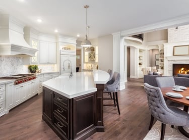 Newly built kitchen featuring custom cabinetry, countertops, flooring, and lighting