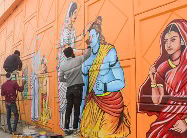 a man is painting a mural of a woman's face