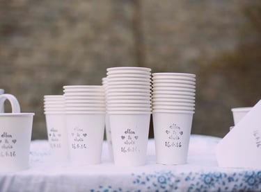 Photo of paper cups with wedding date and bride and groom's names stamped on