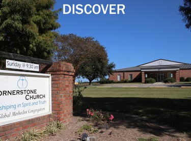 Front of church building with sign.