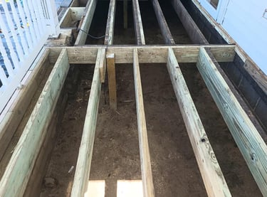 An old porch was transformed with composite decking in Ligonier, IN (2nd photo).