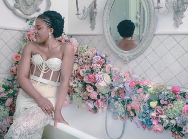 a woman in a white dress sitting on a bathtub